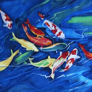 May include: A watercolor painting of a school of colorful koi fish swimming in a blue pond. The fish are painted in shades of red, orange, yellow, and white.