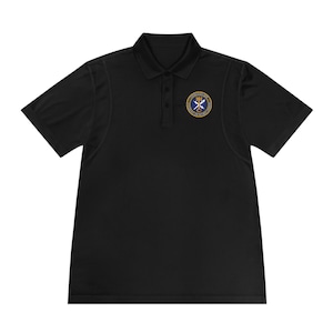 May include: Black polo shirt with a collared neckline and short sleeves. The shirt features a small, circular emblem on the left chest with a blue and gold design. The shirt has a three-button placket and is made of a smooth, likely synthetic fabric.