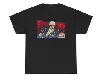 May include: Black t-shirt featuring a cartoon image of a muscular man with sunglasses and a patriotic design. The image includes the text: "You thought I would let you escape Flavortown so easily?"