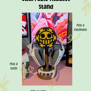 May include: A swappable headset stand with a brown base, stem, and a yellow and black faceplate. The stand holds a white and gray headset. Text on the image reads "Swappable Headset Stand", "Pick a faceplate", "Pick a stem", and "Pick a base".