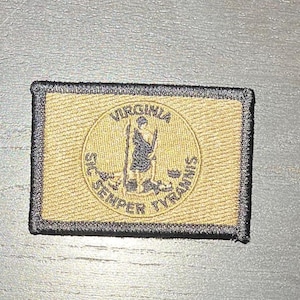 May include: A black and tan embroidered patch with the seal of the Commonwealth of Virginia. The seal features a figure standing on a pedestal with a sword in one hand and a shield in the other. The text around the seal reads "SIC SEMPER TYRANNIS" and "VIRGINIA".