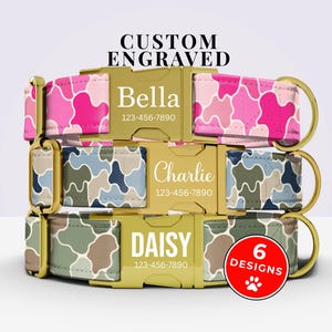 May include: Three dog collars with gold-tone metal buckles featuring custom engraving. The top collar has a pink camouflage pattern with the name Bella, the middle has a blue camouflage pattern with Charlie, and the bottom has a green pattern with DAISY.