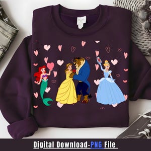 May include: A dark purple sweatshirt featuring a graphic of Disney princesses and the Beast, surrounded by pink hearts. The princesses include Ariel, Belle, and Cinderella. The text "Digital Download - PNG File" is at the bottom.