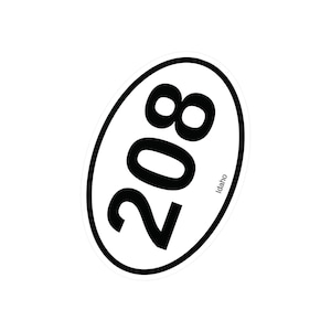 May include: Oval sticker with the number "208" in bold black font, set against a white background. The sticker has a black border and the word "Idaho" is printed in small black font.