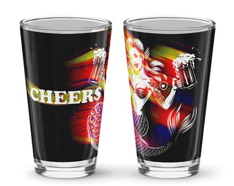 May include: Two pint glasses with a black background. One glass has the word "CHEERS" in white with a colorful streak. The other glass features a mermaid holding a beer stein. The mermaid has red hair and a mermaid tail. The glasses are for beer.