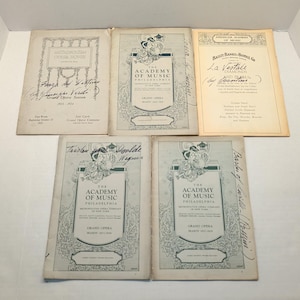 May include: A set of three ceramic mugs with a speckled, matte finish. The mugs are in shades of cream, light gray, and dark gray. Each mug has a simple, minimalist design and a rounded handle.