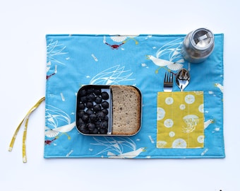 At the seaside placemat with seagulls, crabs, feathers. Travel place mat in turquoise blue and yellow for sea lover.