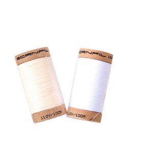 Organic cotton sewing thread in white, natural, red, blue, orange, yellow, pink, blue, green, brown, or black. Scanfil wooden spool thread image 3