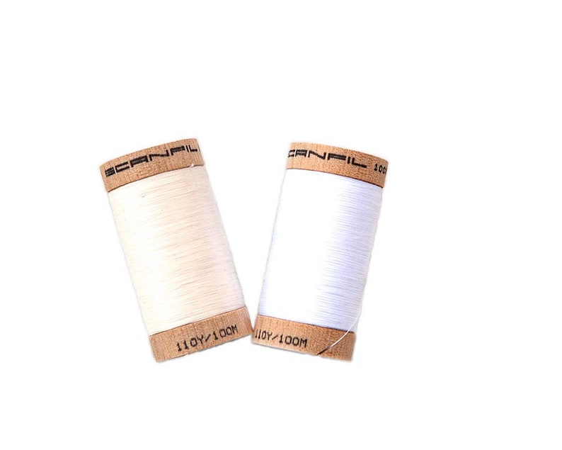 Organic cotton sewing thread in white, natural, red, blue, orange, yellow, pink, blue, green, brown, or black. Scanfil wooden spool thread image 3