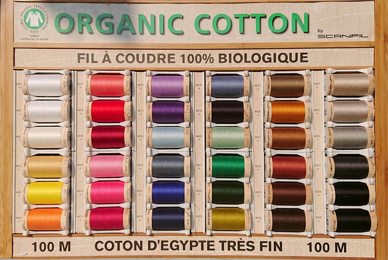 Organic cotton sewing thread in white, natural, red, blue, orange, yellow, pink, blue, green, brown, or black. Scanfil wooden spool thread image 4