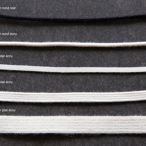 May include: Five different sizes of elastic cord, ranging from 2.2 mm to 9.5 mm in diameter. The cord is available in black and ecru colors. The cord is flat and has a smooth texture.