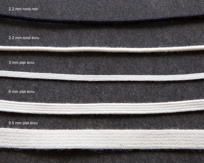 May include: Five different sizes of elastic cord, ranging from 2.2 mm to 9.5 mm in diameter. The cord is available in black and ecru colors. The cord is flat and has a smooth texture.