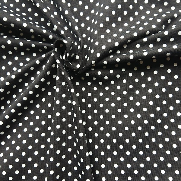 Jersey à pois blancs sur noir. Jersey élastique de coton bio certifié GOTS par 50cm.