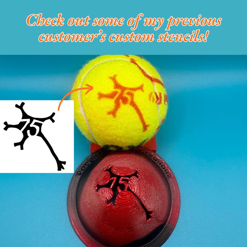 May include: A bright yellow tennis ball featuring an orange neuron-shaped stencil design with the number 75 in the center. Below the ball sits a red 3D-printed circular stencil tool with the same neuron and 75 design cut out of the center.