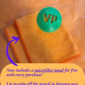 May include: A bright orange microfiber towel with orange stitched edges, paired with a circular green plastic stencil featuring the letters VP cut out from the center. The image includes text stating: Now includes a microfiber towel for free with every purchase! Use to wipe off the stencil in between uses.