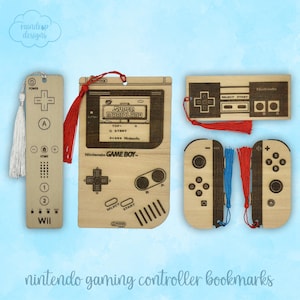 May include: Wooden bookmarks featuring Nintendo gaming controller designs. Includes a Wii remote, a Game Boy, a Nintendo controller, and two Switch Joy-Cons. Each bookmark has a tassel. The text "Nintendo gaming controller bookmarks" is at the bottom.