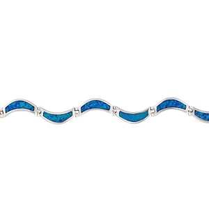 May include: A silver bracelet with a wavy design. The bracelet has alternating sections of silver and blue opal-like stones. The clasp is a simple lobster claw style. The bracelet is a delicate piece of jewellery.