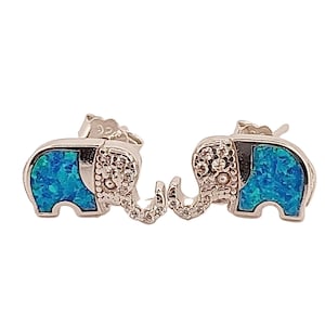 May include: A pair of silver elephant stud earrings with blue opal inlays. The elephants are facing each other with their trunks touching.