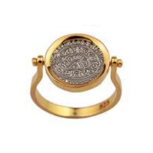 May include: A gold-colored ring with a circular, silver-colored coin set in the center. The coin has intricate designs and text. The ring's band is a simple, smooth design. The coin is held in place by two small posts.