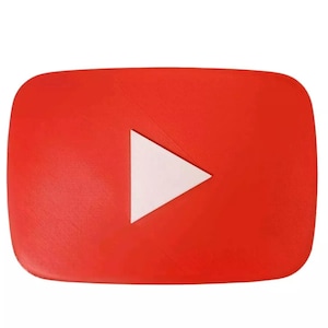 May include: A red, rectangular YouTube logo with rounded corners. A white triangle, the play button, is centered on the red background. The logo is set against a white background.
