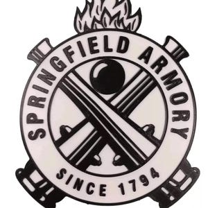 May include: Black and white logo with the text "Springfield Armory Since 1794" in a circle. The logo features a flame, two crossed rifles, and a cannonball.