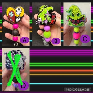 May include: A collection of four retractable badge holders featuring characters from "The Nightmare Before Christmas." Each holder has a different design, including Jack Skellington and Sally, and the Oogie Boogie. The holders have colorful beads and a metal clip.