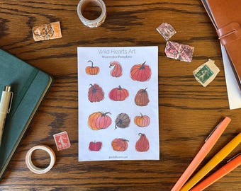May include: A sheet of stickers featuring watercolor illustrations of pumpkins in various shades of orange, red, and yellow. The stickers are titled "Wild Hearts Art Watercolor Pumpkins" and include the artist's Instagram handle, "@wildheartsart".