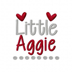 May include: A gray and red embroidered design with the text "Little Aggie" and two red hearts above the text. A row of gray dots is below the text.