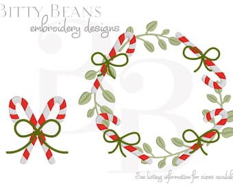 May include: A digital embroidery design featuring a Christmas wreath and two candy canes. The wreath is composed of green leaves, red and white striped candy canes, and green bows. The candy canes are also shown crossed with a green bow.