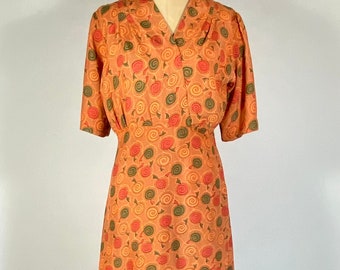 Vintage 1930’s to 40’s over dyed orange cold rayon dress with swirl print