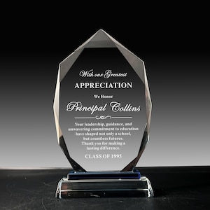 May include: A clear, faceted crystal award with a blue base. The text reads "With our Greatest APPRECIATION We Honor Principal Collins" and a message of gratitude. The words "CLASS OF 1995" are at the bottom.