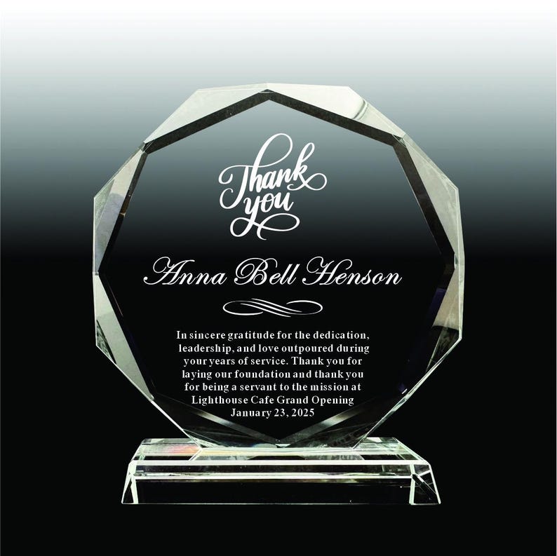 Puede incluir: Un premio de cristal claro y facetado con las palabras "Thank you" y "Anna Bell Henson" en una elegante escritura. El premio incluye una inscripci&oacute;n que expresa gratitud por la dedicaci&oacute;n y el servicio, con fecha del 23 de enero de 2025.