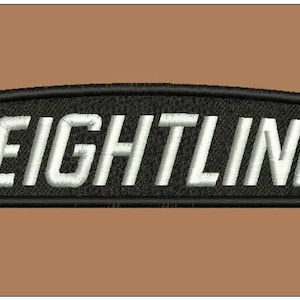 Puede incluir: Parche bordado en blanco y negro con la palabra "FREIGHTLINER" en letras blancas.