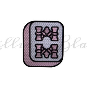 May include: A pink and white mahjong tile with the number "8" in black.