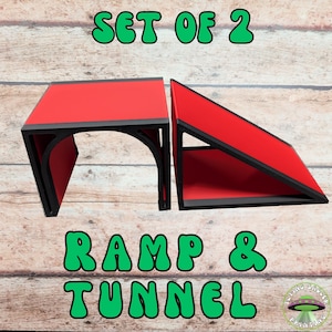 May include: A set of two red and black ramps and tunnels. The text "SET OF 2" and "RAMP & TUNNEL" are in green bubble letters. The Flying Saucer Printing logo is in the bottom right corner.