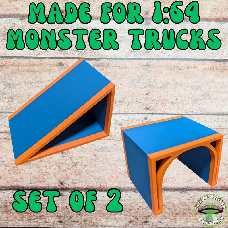 May include: Two blue and orange structures for 1:64 monster trucks. The structures are a set of two, with the text "MADE FOR 1:64 MONSTER TRUCKS" and "SET OF 2" in green. The structures have an orange trim.
