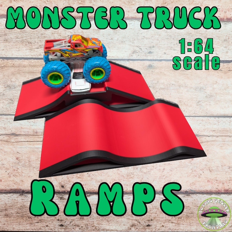 May include: Red toy ramps with black trim, designed for monster trucks. A colorful monster truck toy is positioned on the ramp. The text "MONSTER TRUCK" and "RAMPS" are displayed in green bubble letters. The scale is 1:64.