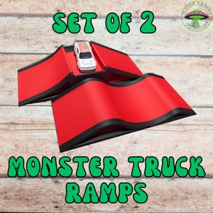 May include: Set of two red monster truck ramps with black trim, and a small toy car with red and white stripes. The ramps are on a wooden surface. Text on the image reads "SET OF 2" and "MONSTER TRUCK RAMPS".