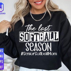 May include: Black sweatshirt with white text that reads "The last softball season #SeniorSoftballMom".