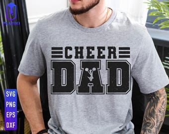 May include: Gray t-shirt with black text that reads "Cheer Dad" with a graphic of a cheerleader in the middle of the word "Dad".