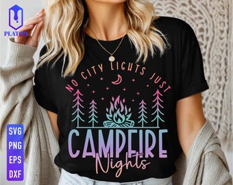 May include: Black t-shirt with a colourful graphic design featuring a campfire, trees, and the text "NO CITY LIGHTS JUST CAMPFIRE Nights". The design includes a crescent moon and stars.