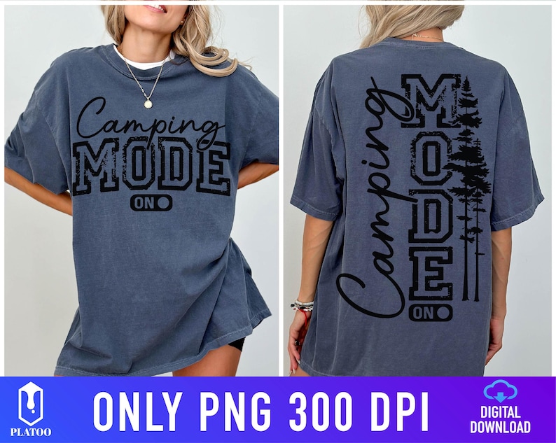 May include: A slate blue t-shirt with the words "Camping MODE ON" in black script and block letters. The back of the shirt features the same text vertically, along with a silhouette of pine trees. The shirt is a relaxed fit.