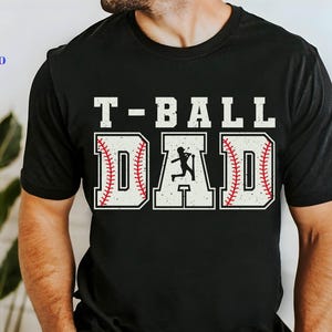 Puede incluir: Camiseta negra con el texto "T-BALL DAD" en blanco, con letras tem&aacute;ticas de b&eacute;isbol y una silueta de un jugador de b&eacute;isbol. La camiseta tambi&eacute;n tiene las palabras "SVG, PNG, EPS, DXF" en una columna vertical.