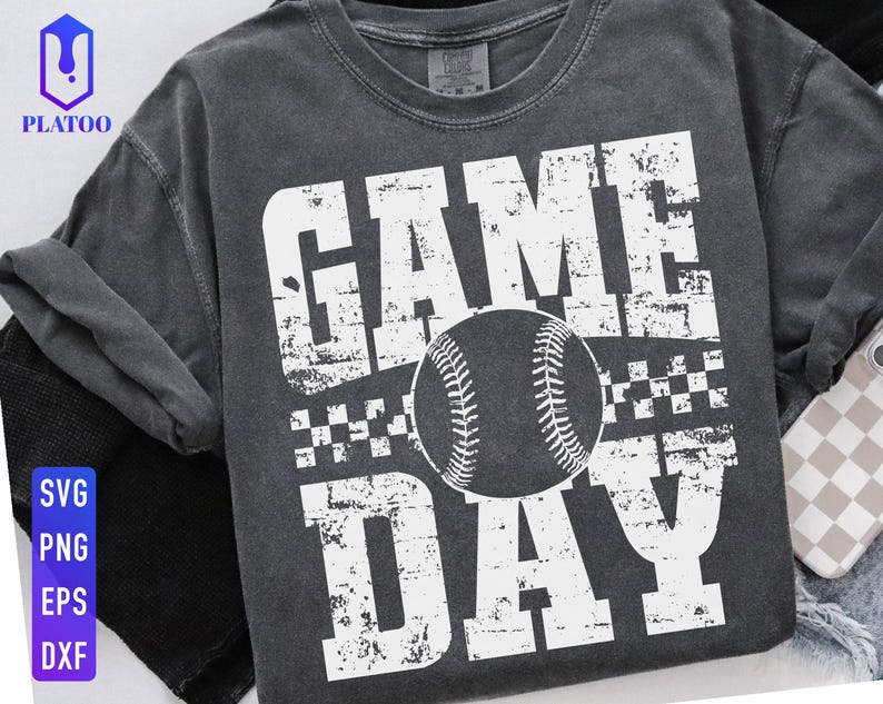 May include: Dark grey baseball-themed t-shirt with the words "GAME DAY" in distressed white lettering. A baseball graphic is centered between the words. The shirt also has a checkered pattern.