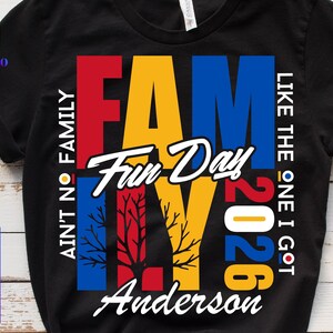 May include: Black t-shirt with a colorful graphic design. The design features the word "FAMILY" in red, yellow, and blue, with "Fun Day" in white script. Additional text includes "AIN'T NO FAMILY", "LIKE THE ONE I GOT", "2026", and "Anderson".