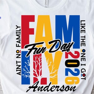 May include: White t-shirt with a colorful graphic design. The design features the word "FAMILY" in large, bold letters, with the words "Fun Day 2026" and "Anderson" below. Additional text includes "AIN'T NO FAMILY" and "LIKE THE ONE I GOT".