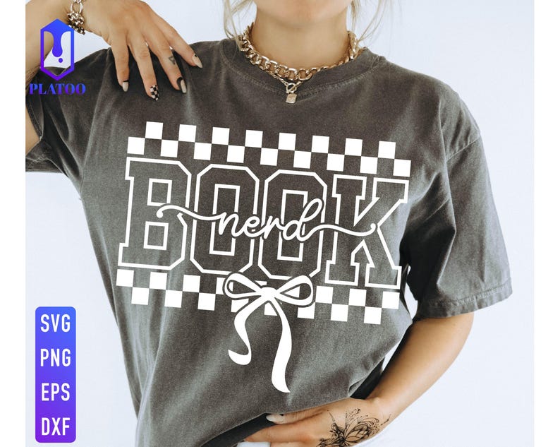 May include: Dark gray t-shirt with the words "BOOK nerd" in white block letters and a white bow. The word "nerd" is in a cursive font. The shirt has a checkered pattern above and below the text. The shirt also has the words "SVG, PNG, EPS, DXF" in blue and white.