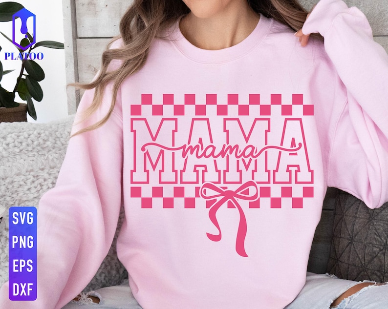 May include: A light pink sweatshirt with the word "MAMA" in a pink block letter design, with a pink bow at the bottom. The word "mama" is in a cursive font. The sweatshirt has a checkered pattern above the word "MAMA".