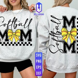 May include: A light gray sweatshirt with the words "Softball Mom" in black script and block letters. A yellow softball bow is centered on the front and back. The design includes a black and white checkered pattern.