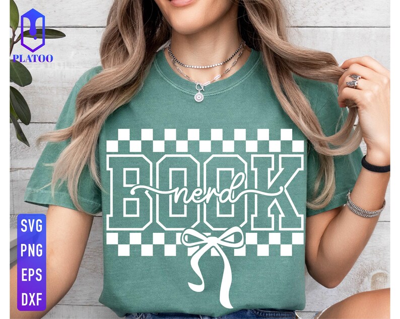 May include: A teal green t-shirt with the word "BOOK nerd" in white block letters and a bow graphic. The shirt has a checkered pattern above and below the text. The left side of the shirt has the text "SVG PNG EPS DXF".
